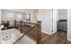 Upstairs landing featuring wood floors, a wrought iron banister, and a laundry area at 3747 Silvery Way, Powder Springs, GA 30127