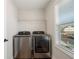 Convenient laundry room with modern washer and dryer, natural light, and storage at 3747 Silvery Way, Powder Springs, GA 30127