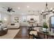 Open-concept floor plan with a kitchen island, pendant lights, and comfortable seating at 3747 Silvery Way, Powder Springs, GA 30127