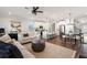 Open-concept living area with stylish furnishings, modern lighting, and a seamless flow between spaces at 3747 Silvery Way, Powder Springs, GA 30127