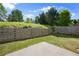 Backyard with wood retaining wall, patio, grass and fence at 3940 Village Estates Ct, Cumming, GA 30040