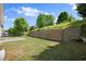 Backyard with tiered retaining wall, grass, patio and shade trees at 3940 Village Estates Ct, Cumming, GA 30040