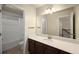 Well-lit bathroom with a white shower/tub and sleek vanity with large mirror at 3940 Village Estates Ct, Cumming, GA 30040