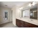 Bathroom showcasing dual sinks, dark wood cabinetry, large mirror, and shower and tub with glass at 3940 Village Estates Ct, Cumming, GA 30040