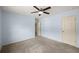 Spacious bedroom with neutral carpet and two doors and an overhead fan at 3940 Village Estates Ct, Cumming, GA 30040