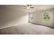 Spacious bedroom with neutral carpet, a ceiling fan, and natural light from two windows at 3940 Village Estates Ct, Cumming, GA 30040