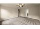 Expansive bedroom featuring neutral carpet, a ceiling fan, and ensuite access at 3940 Village Estates Ct, Cumming, GA 30040
