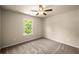 Inviting bedroom with a window offering green tree views and a ceiling fan at 3940 Village Estates Ct, Cumming, GA 30040