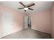 Neutral carpeted bedroom featuring a ceiling fan and two white doors at 3940 Village Estates Ct, Cumming, GA 30040