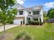 Well-maintained home with a lush lawn, a two-car garage, and charming curb appeal at 3940 Village Estates Ct, Cumming, GA 30040