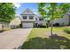 Charming two-story home featuring a well-manicured lawn, attached garage, and a welcoming front porch at 3940 Village Estates Ct, Cumming, GA 30040