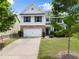 Beautiful two-story home with a brick and siding exterior, well-manicured lawn, and attached garage at 3940 Village Estates Ct, Cumming, GA 30040