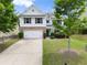 Charming two-story home featuring a well-maintained front yard, long driveway, and a two-car garage at 3940 Village Estates Ct, Cumming, GA 30040