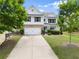 Charming two-story home featuring a well-maintained front yard, long driveway, and a two-car garage at 3940 Village Estates Ct, Cumming, GA 30040