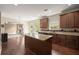 Open kitchen with granite countertops, stainless steel appliances, and a view into a spacious living area at 3940 Village Estates Ct, Cumming, GA 30040