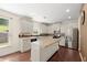 Bright kitchen with white cabinets, granite countertops, stainless steel appliances, and a functional center island at 3940 Village Estates Ct, Cumming, GA 30040