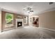 Living room with fireplace and view into the kitchen for entertaining at 3940 Village Estates Ct, Cumming, GA 30040