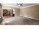 Open living room with neutral carpet and view into kitchen at 3940 Village Estates Ct, Cumming, GA 30040