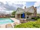 Community swimming pool with an outdoor seating area, lounge chairs, and landscaped surroundings at 3940 Village Estates Ct, Cumming, GA 30040