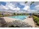 Community swimming pool with lounge chairs and umbrellas surrounded by well-maintained landscaping and homes at 3940 Village Estates Ct, Cumming, GA 30040