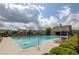 Community swimming pool with lounge chairs and umbrellas surrounded by well-maintained landscaping and homes at 3940 Village Estates Ct, Cumming, GA 30040