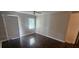 Cozy living room with hardwood floors, ceiling fan, and a door leading to the outside at 4185 Brookwood Dr, Austell, GA 30106