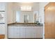 Bathroom featuring granite countertop vanity with a large mirror and ample storage space at 4835 Merlendale Ct, Atlanta, GA 30327