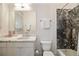 Clean bathroom featuring a marble countertop, and bathtub with black marble tile surround at 4835 Merlendale Ct, Atlanta, GA 30327