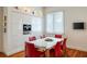 Modern dining area with a white table, red chairs, contemporary cabinetry, and built in appliances at 4835 Merlendale Ct, Atlanta, GA 30327