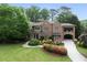 Attractive brick home with landscaped front yard, stone accents, covered parking, and a well-maintained lawn at 4835 Merlendale Ct, Atlanta, GA 30327