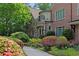 Close up of brick home with stone accents, beautiful landscaping, mature trees, and well-maintained flower beds at 4835 Merlendale Ct, Atlanta, GA 30327
