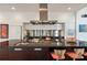 Close up of the modern kitchen with stainless steel appliances, a large island with seating, and sleek cabinetry at 4835 Merlendale Ct, Atlanta, GA 30327