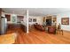 Bright and open living room with hardwood floors, built-in shelving, and a view into the modern kitchen at 4835 Merlendale Ct, Atlanta, GA 30327
