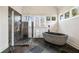 Spa-like bathroom with a modern shower, freestanding tub, and large windows that let in natural light at 4835 Merlendale Ct, Atlanta, GA 30327