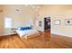 Spacious main bedroom with hardwood floors, natural light, vaulted ceilings, and a glimpse of a walk-in closet at 4835 Merlendale Ct, Atlanta, GA 30327