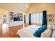 Large main bedroom with built-in shelving, hardwood floors, vaulted ceilings, and access to a private balcony at 4835 Merlendale Ct, Atlanta, GA 30327