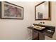 Modern powder room with a unique gold sink, black granite countertop, and stylish design at 4835 Merlendale Ct, Atlanta, GA 30327