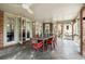 Cozy sunroom with a dining table, slate floors, ceiling fans, and folding doors that open to the kitchen at 4835 Merlendale Ct, Atlanta, GA 30327