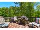 Outdoor deck featuring comfortable chairs and a grill, perfect for outdoor entertaining and relaxation at 1010 Augusta Woods Dr, Douglasville, GA 30134