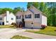 Beautiful split-level house boasting a well-kept lawn, vibrant flower bushes, and a convenient two-car garage at 1010 Augusta Woods Dr, Douglasville, GA 30134