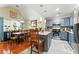 Bright, open kitchen with blue cabinets, granite countertops, stainless steel appliances, and adjacent dining area at 1010 Augusta Woods Dr, Douglasville, GA 30134