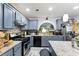Well-equipped kitchen with granite countertops, stainless steel appliances, light blue cabinets, and a mosaic tile backsplash at 1010 Augusta Woods Dr, Douglasville, GA 30134