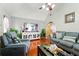 Cozy living room with hardwood floors, large windows, and comfortable seating at 1010 Augusta Woods Dr, Douglasville, GA 30134