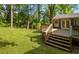 Wooden back deck features steps down to the grassy lawn, perfect for outdoor living at 1541 Pontiac Se Pl, Atlanta, GA 30315