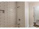 Tiled bathtub and shower with modern fixtures in an updated, bright bathroom at 1541 Pontiac Se Pl, Atlanta, GA 30315