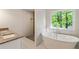 Modern bathroom featuring granite countertops, walk-in shower, and soaking tub at 1541 Pontiac Se Pl, Atlanta, GA 30315