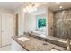 Modern bathroom featuring granite countertops, walk-in shower, and soaking tub at 1541 Pontiac Se Pl, Atlanta, GA 30315