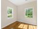 Bright bedroom with hardwood floors and two windows providing natural light at 1541 Pontiac Se Pl, Atlanta, GA 30315