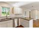 Well-lit kitchen featuring granite countertops, subway tile backsplash, and stainless dishwasher at 1541 Pontiac Se Pl, Atlanta, GA 30315