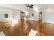 Open-concept living room featuring hardwood floors, fresh white paint, and modern ceiling fan flowing into the kitchen at 1541 Pontiac Se Pl, Atlanta, GA 30315
